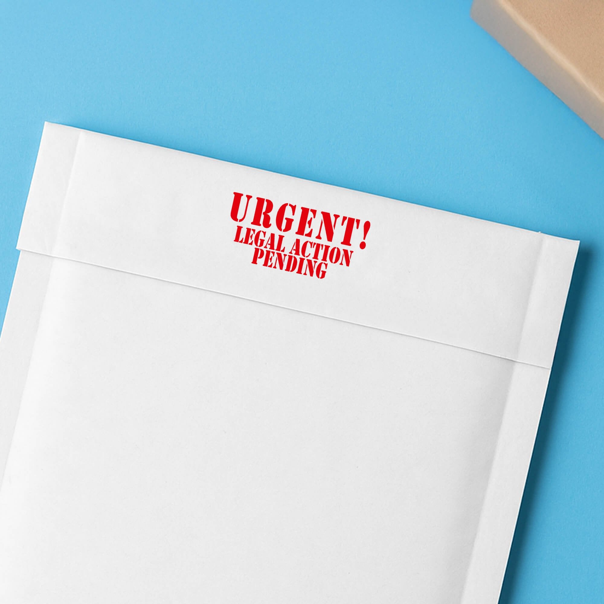 White envelope flap stamped URGENT! Legal Action Pending in red for urgent collections mail