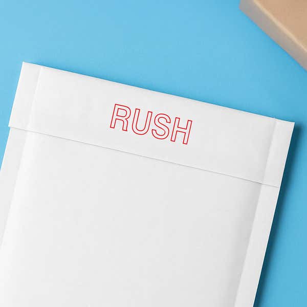 RUSH in red outline stamped on a white envelope flap for expedited mail