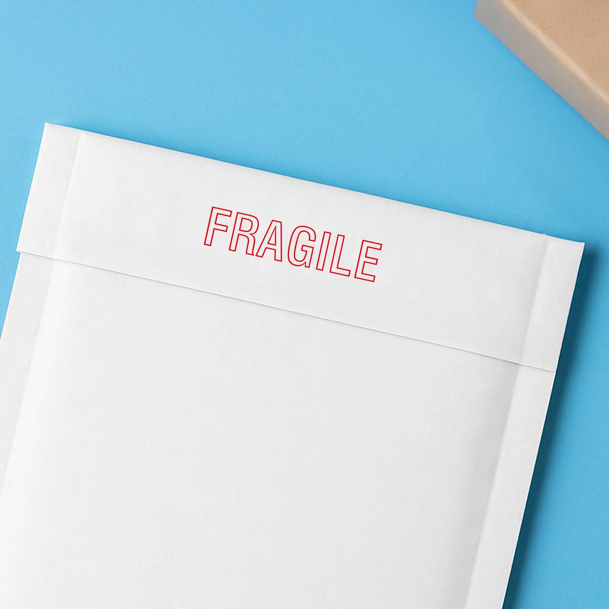 Envelope marked Fragile in red outline to flag careful handling