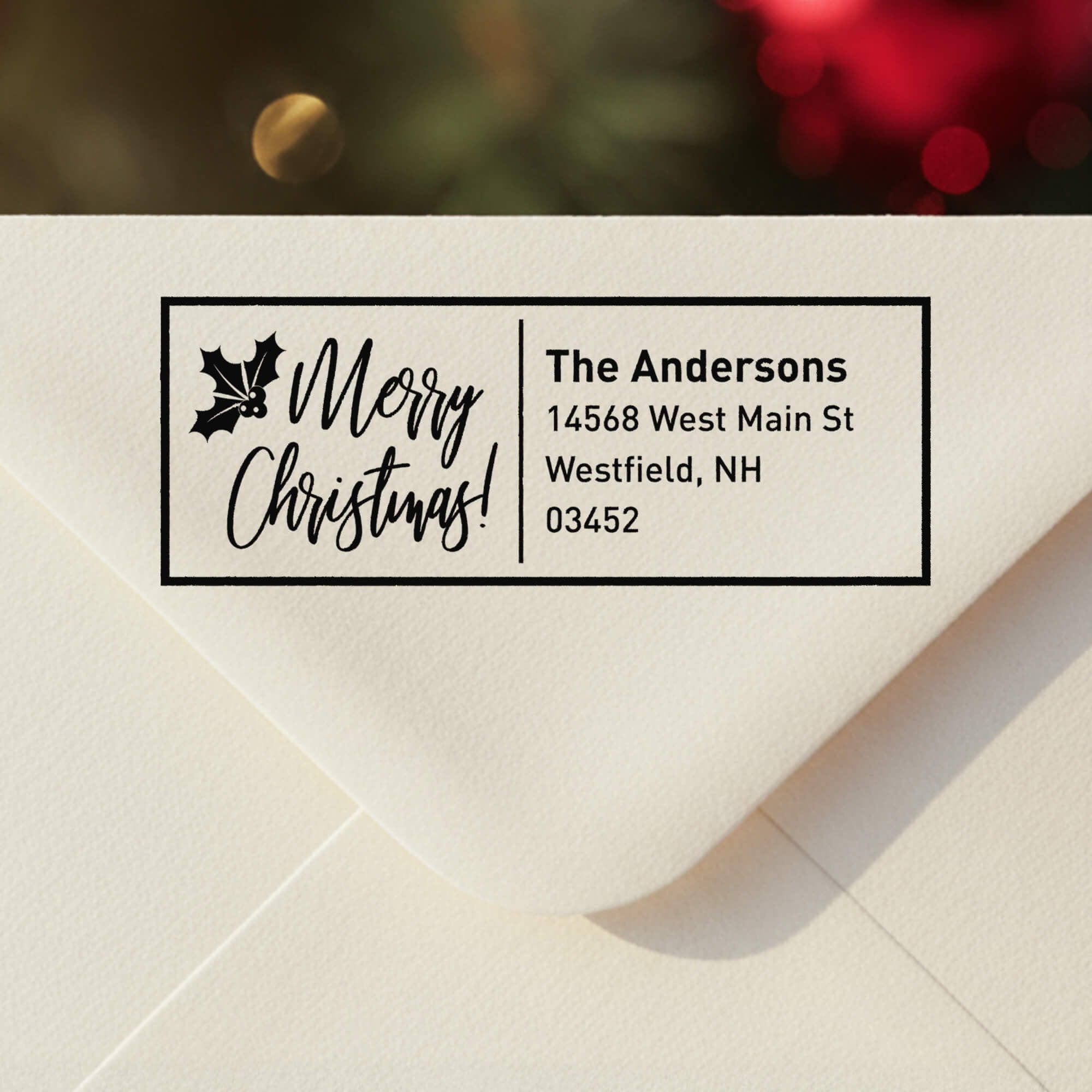 Personalized ‘Merry Christmas With Poinsettia’ address stamp impression on envelope flap for holiday cards.
