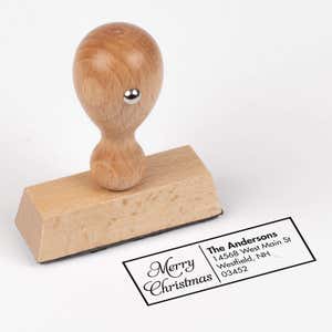 European wood hand stamp shown from above featuring custom ‘Merry Christmas Scripted’ holiday return address design.