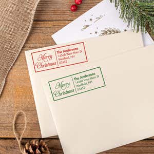 Green and red ink impressions of ‘Merry Christmas Scripted’ return address stamp on Christmas envelopes.