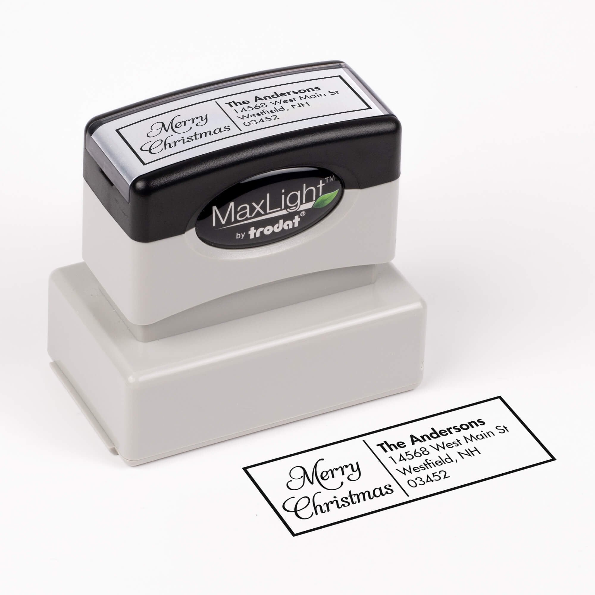 Pre-inked stamp shown from above featuring custom ‘Merry Christmas Scripted’  holiday return address design.
