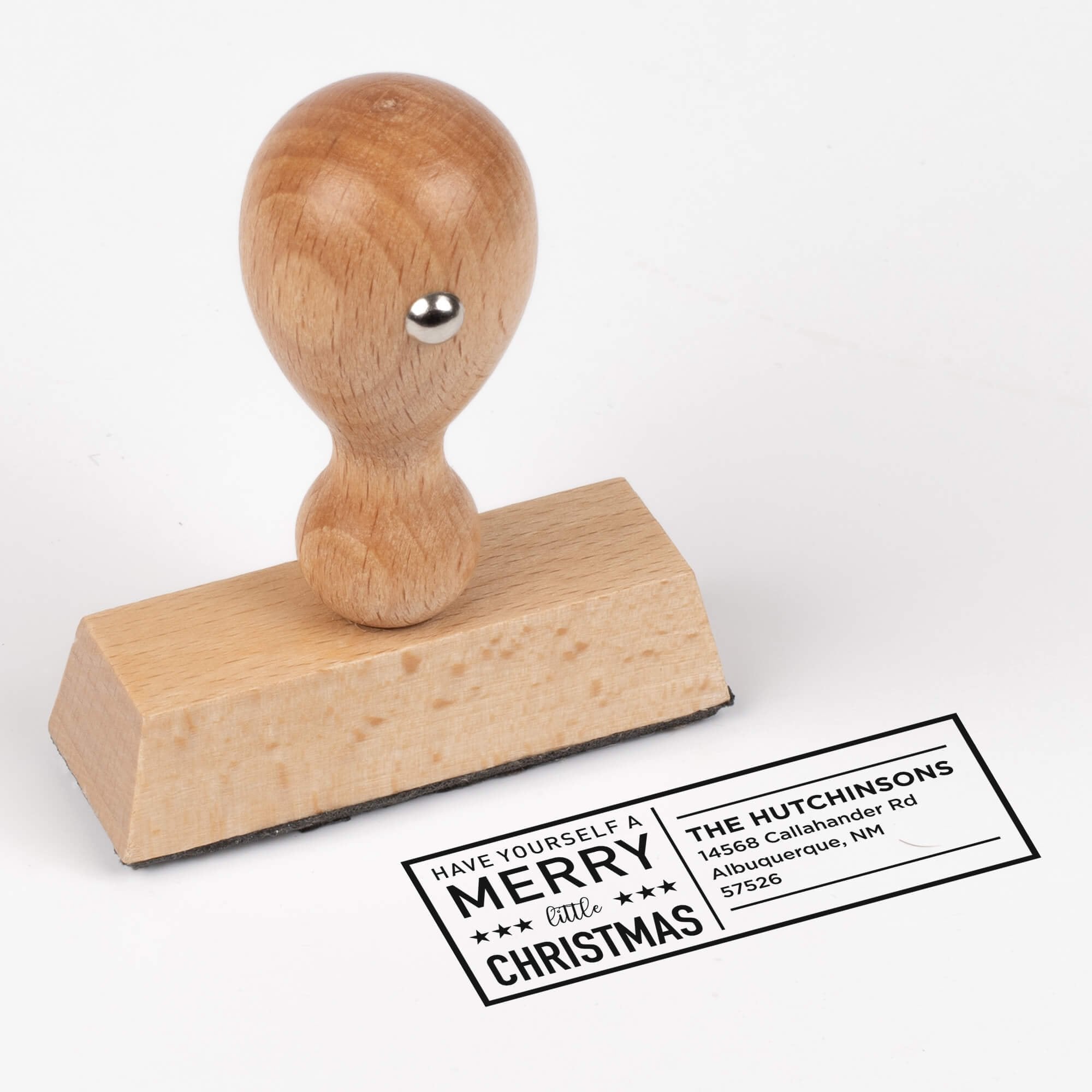 European wood hand stamp shown from above featuring custom ‘Have Yourself A Merry Little Christmas’ holiday return address design.