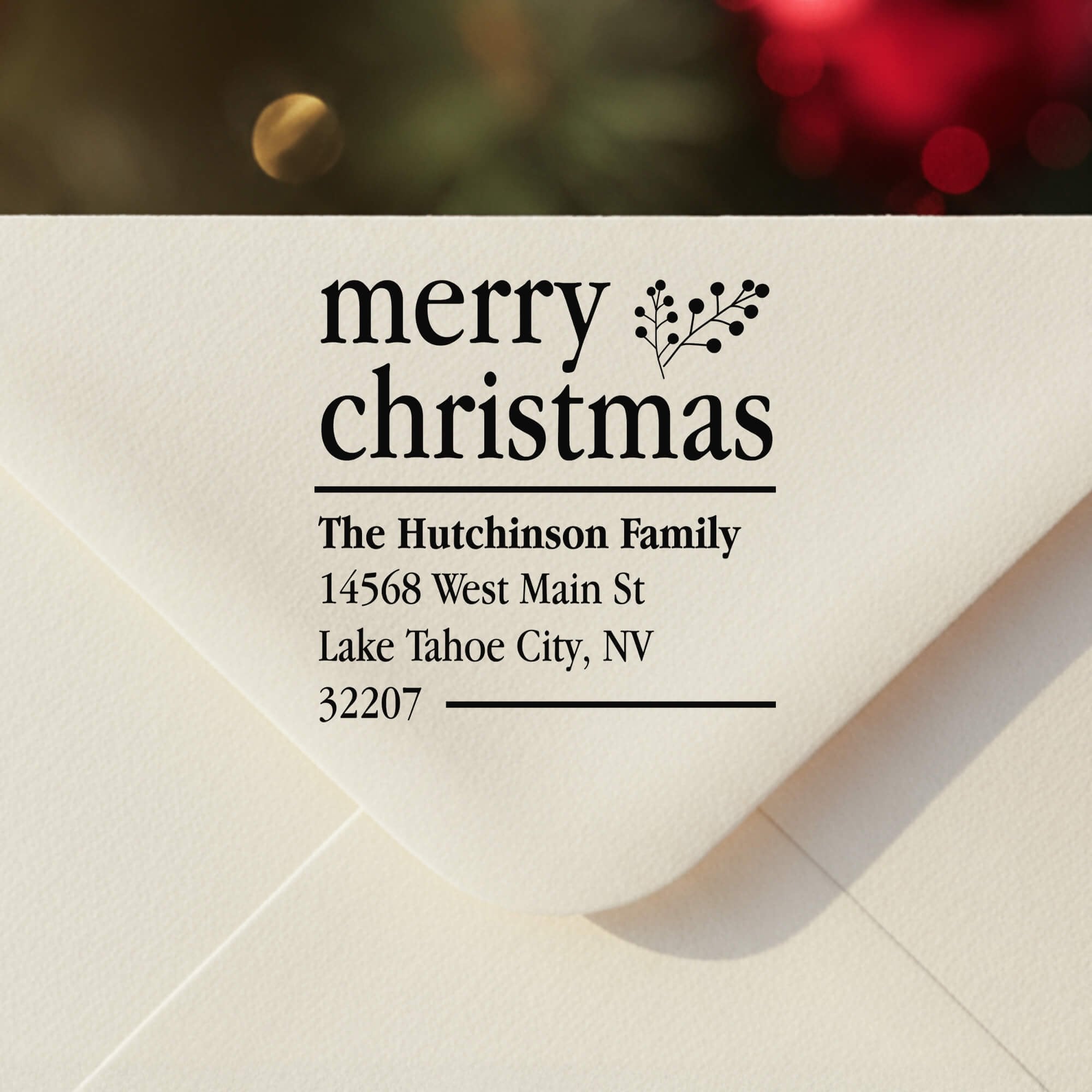 Personalized ‘Merry Christmas With Fern’ address stamp impression on envelope flap for holiday cards.