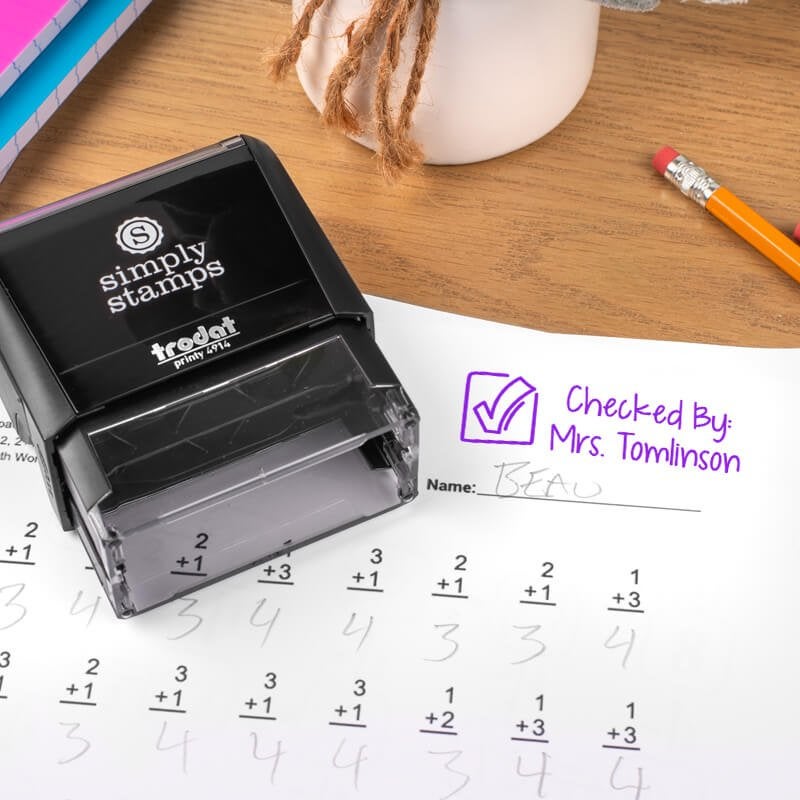 Check mark stamp for teachers on paper.