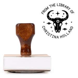 Front view of wood handle stamp body with library book stamp impression