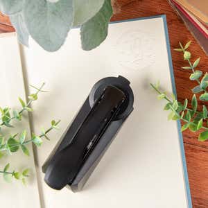 Book embossing stamp top view with book and stamp impression