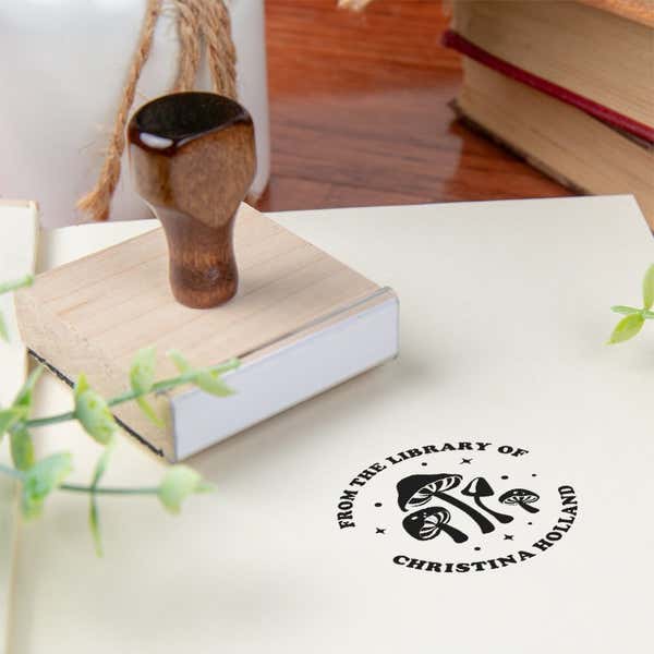 Custom book stamp on paper with wood handle stamp body