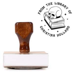 Front view of wood handle stamp body with library book stamp impression