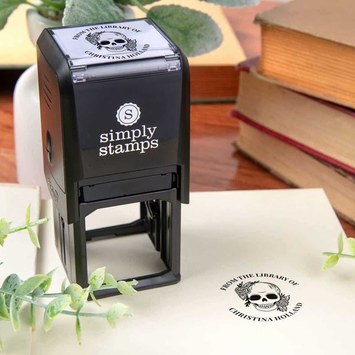 Library book stamp with self-inking stamp body on a book page
