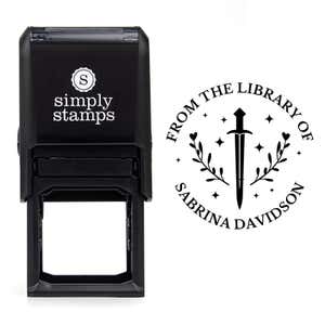 Front view of self-inking stamp body with library book stamp impression example