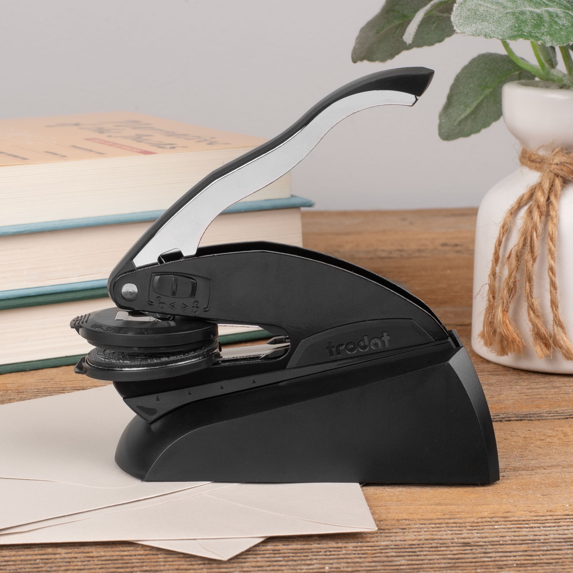 Reader using a custom book embosser on a favorite novel