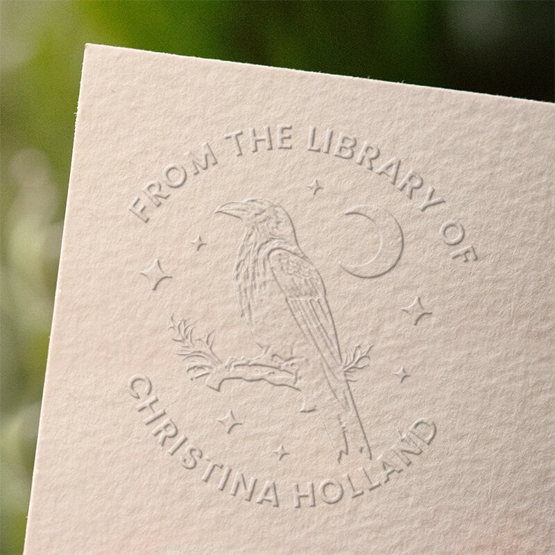 Custom book embosser making an impression inside a personal library book