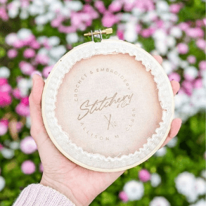 rubber logo stamp on cross stitching