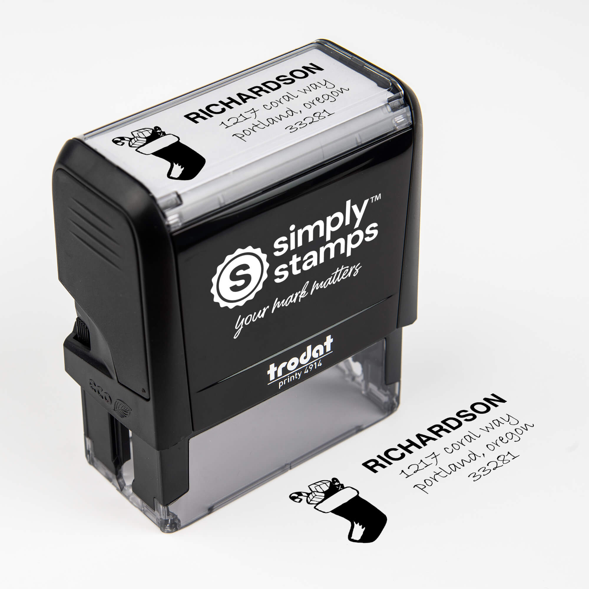 Custom holiday return address stamp used on red and green envelopes