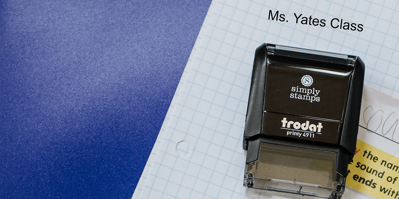 Image of a teacher stamp from Simply Stamps on a school paper